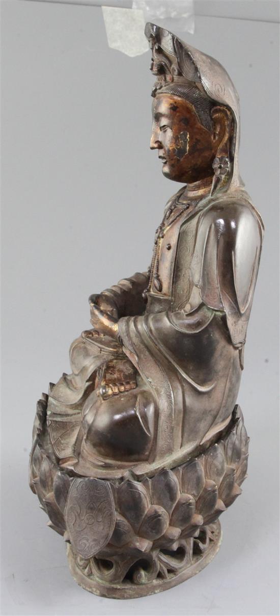 A large Chinese lacquered bronze seated figure of Guanyin, height 35cm